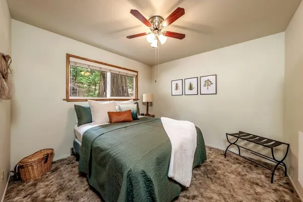 a bedroom with a bed and a chandelier