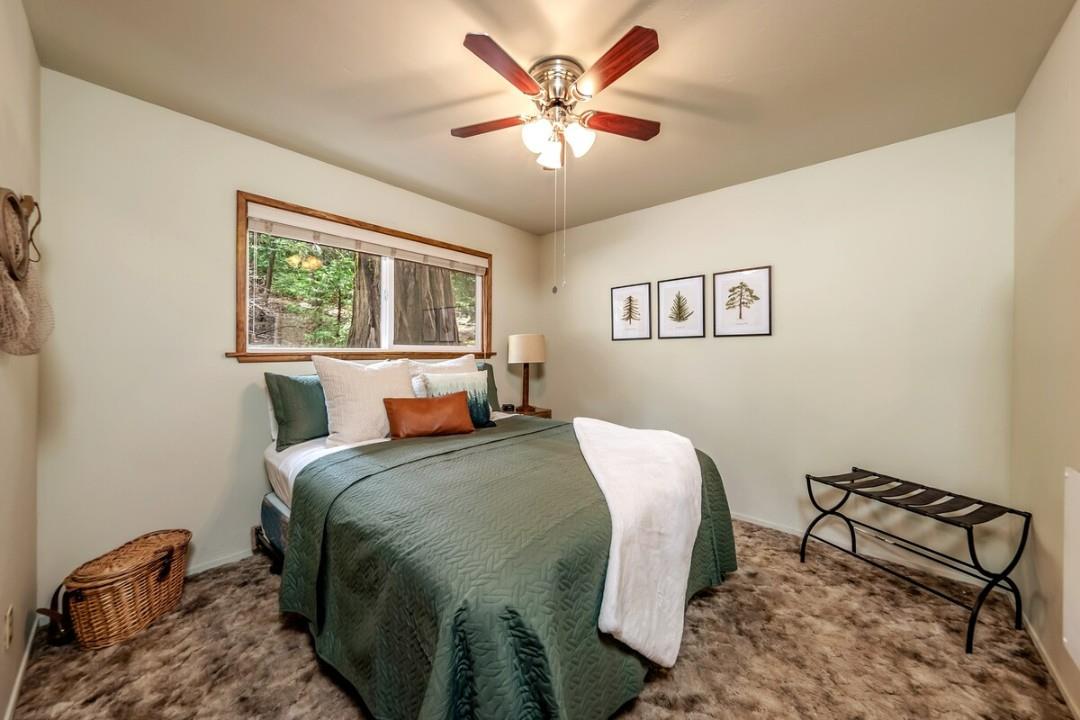 42318 Hanging Branch Road Shaver Lake, CA 93664 - Photo 13 of 13 a bedroom with a bed and a chandelier