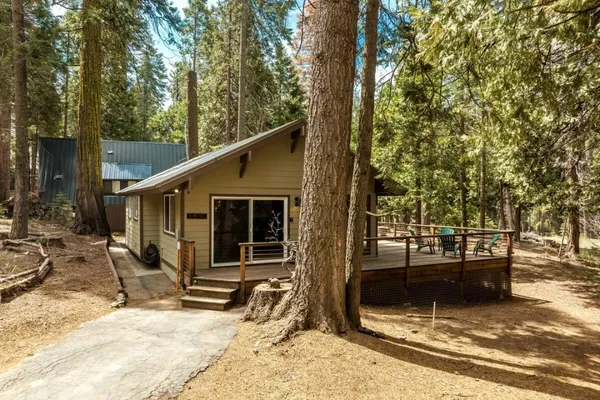 a view of a house with backyard porch and sitting area