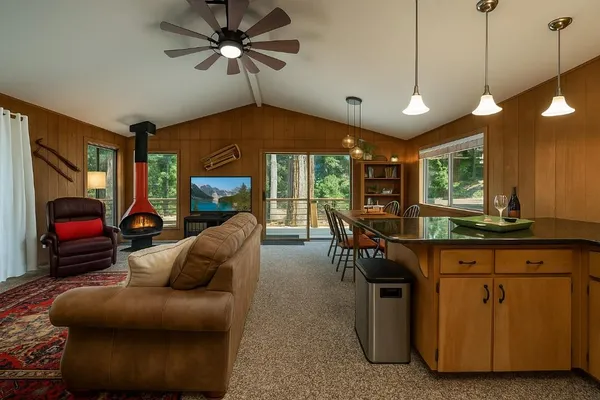 a living room with furniture a ceiling fan and a window