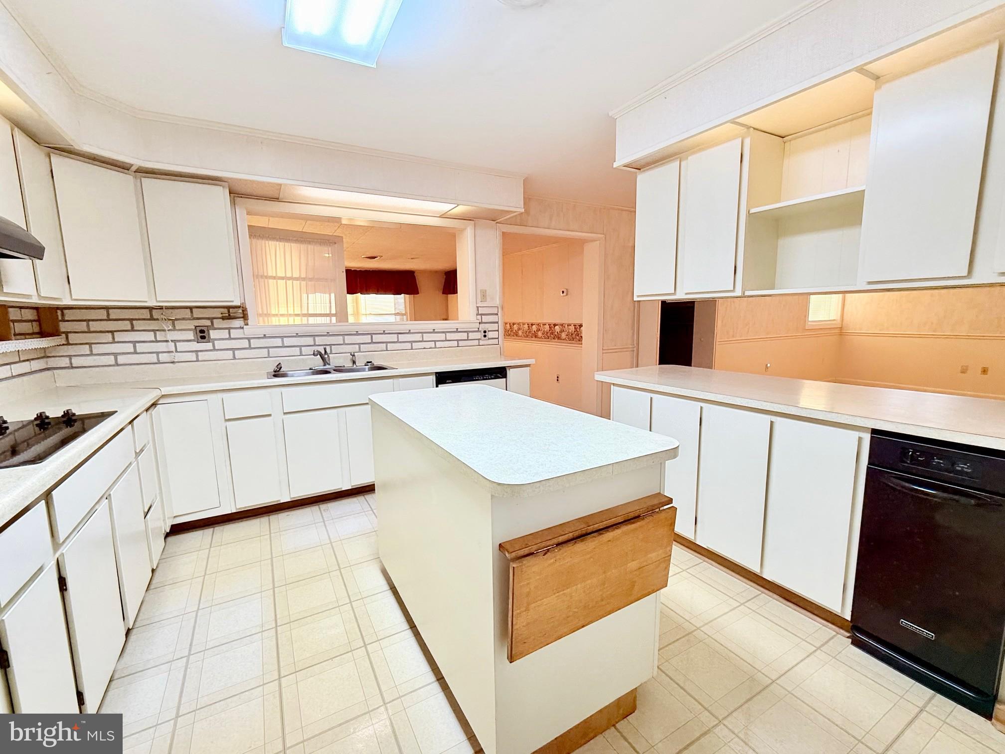 48724 Curleys Road Ridge, MD 20680 - Photo 14 of 44 a kitchen with a stove a sink and a refrigerator