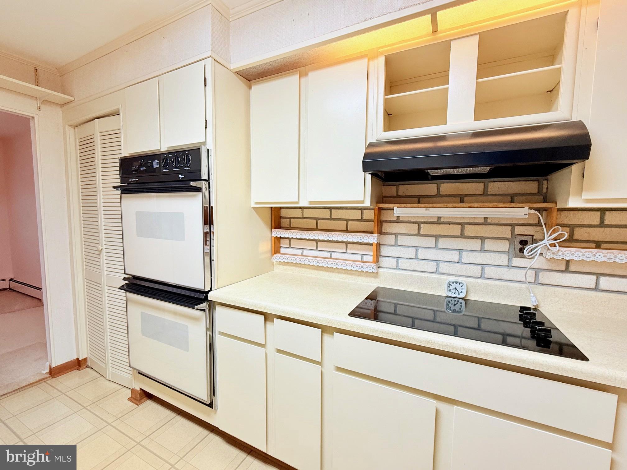 48724 Curleys Road Ridge, MD 20680 - Photo 15 of 44 a kitchen with a refrigerator and a sink