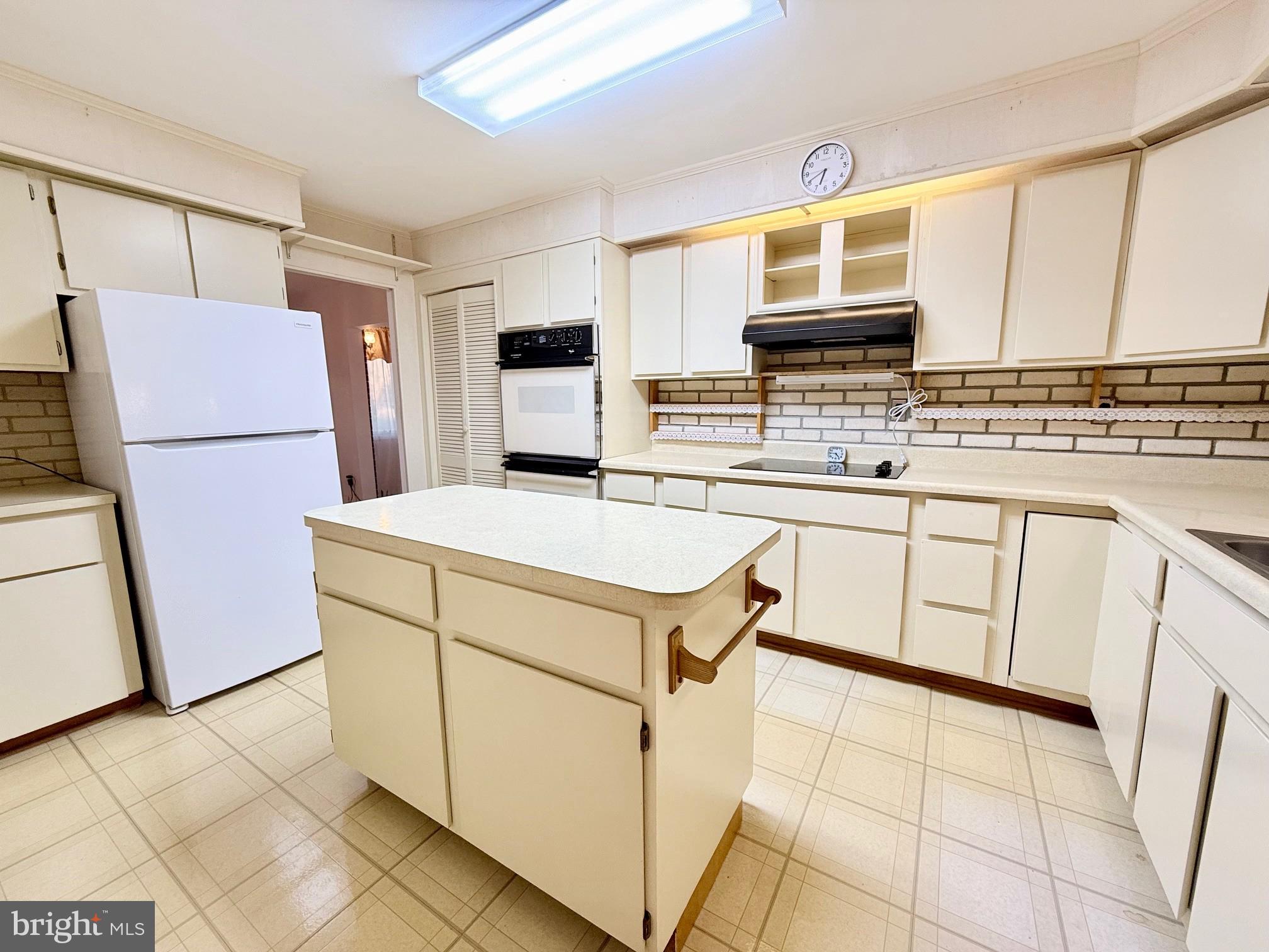 48724 Curleys Road Ridge, MD 20680 - Photo 17 of 44 a kitchen with cabinets and white appliances