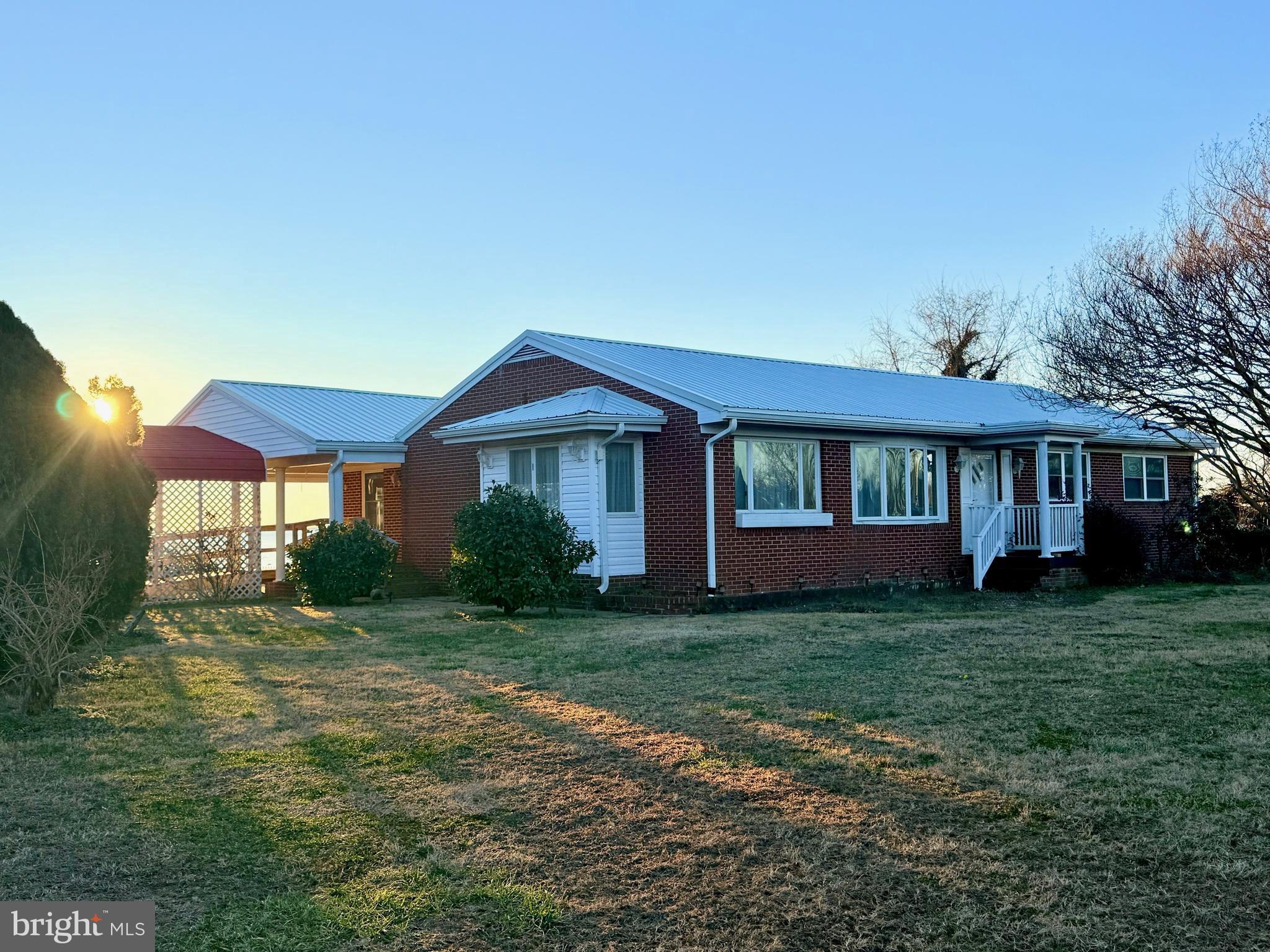 48724 Curleys Road Ridge, MD 20680 - Photo 34 of 44 a front view of a house with a garden