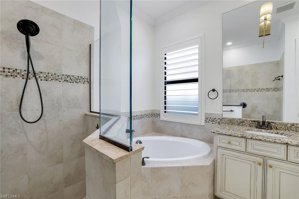 2806 Aviamar Circle Naples, FL 34114 - Photo 17 of 50 a bathroom with a granite countertop sink a shower and a mirror