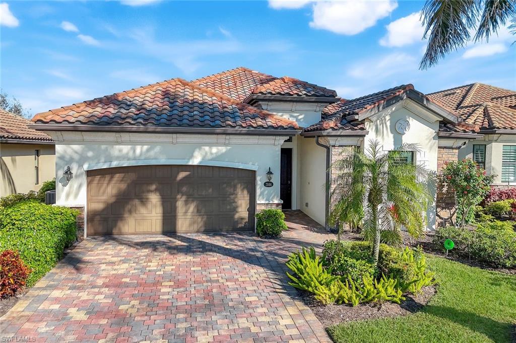2806 Aviamar Circle Naples, FL 34114 - Photo 2 of 50 a front view of a house with a garden