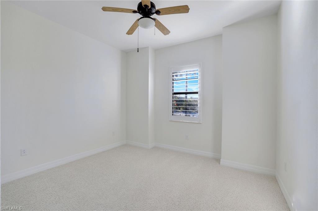 2806 Aviamar Circle Naples, FL 34114 - Photo 21 of 50 an empty room with windows and fan view
