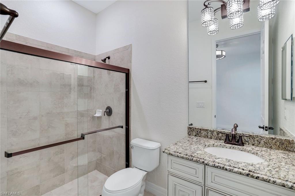 2806 Aviamar Circle Naples, FL 34114 - Photo 23 of 50 a bathroom with a granite countertop sink toilet and shower
