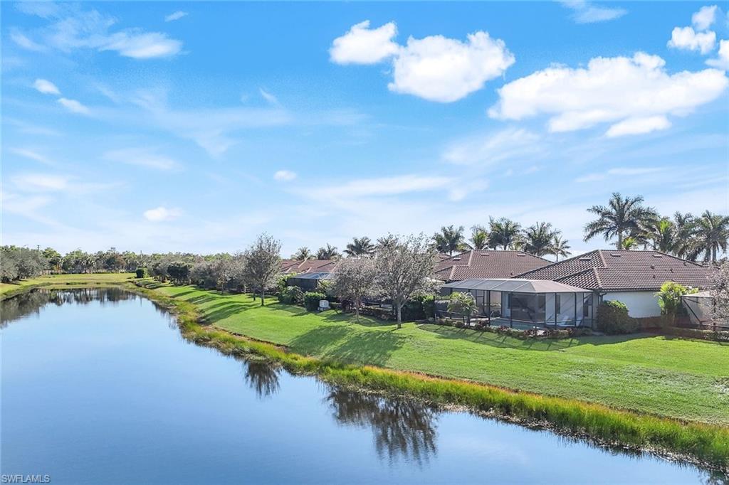 2806 Aviamar Circle Naples, FL 34114 - Photo 34 of 50 a view of a house with a yard and a lake view
