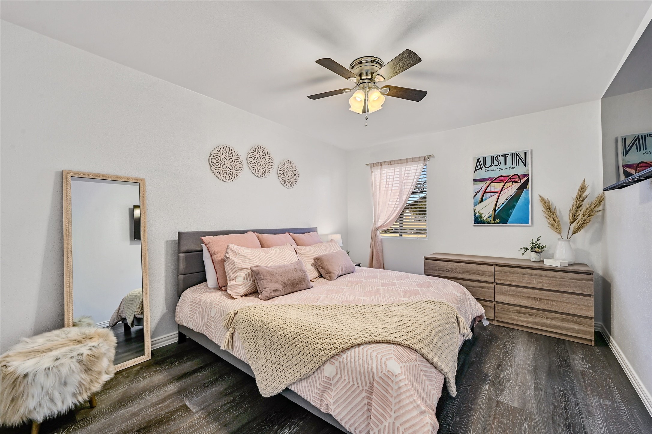 115 Comanche Drive Point Venture, TX 78645 - Photo 15 of 40 a bedroom with a bed and a chandelier