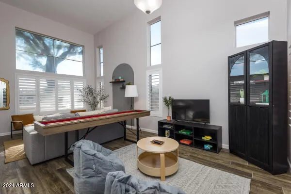 a living room with furniture a chandelier and a table