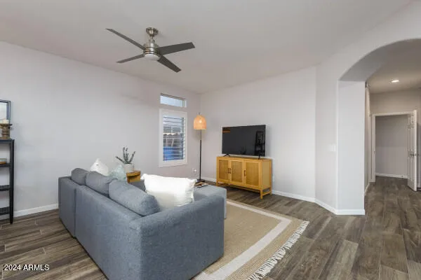 a bedroom with a large bed and a ceiling fan