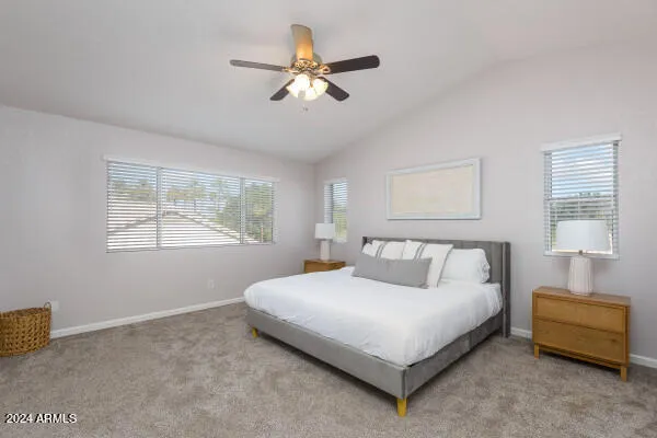 a bedroom with a bed and a ceiling fan