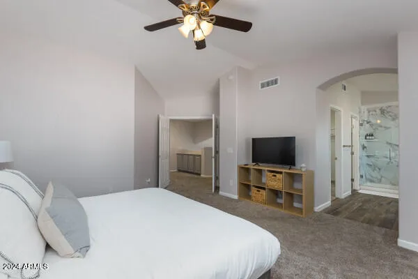 a bedroom with a bed and a night stand