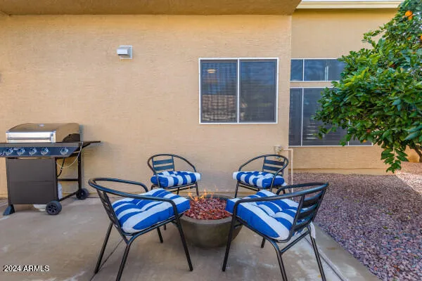 a view of a patio with a table and chairs under an umbrella