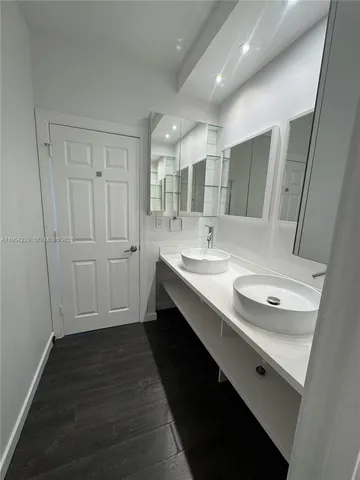 a bathroom with a double vanity sink and mirror