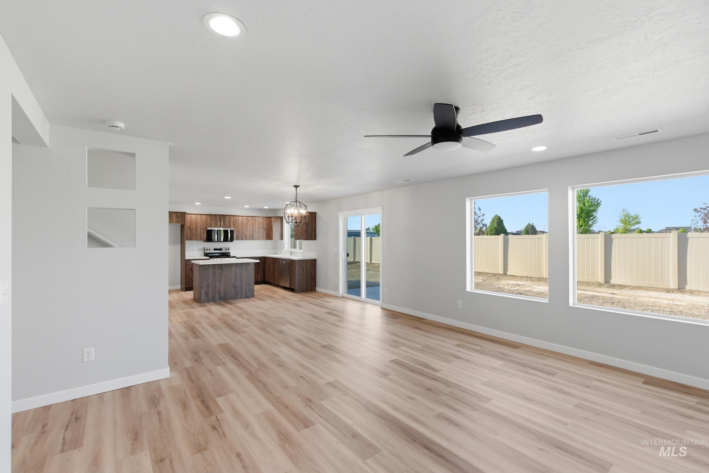 13709 Redway Court Caldwell, ID 83607 - Photo 9 of 28 Spacious interior featuring wood-finish flooring, recessed lighting, and a modern ceiling fan