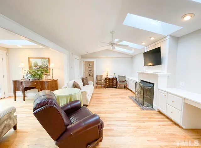 a bathroom with a granite countertop sink a mirror and shower