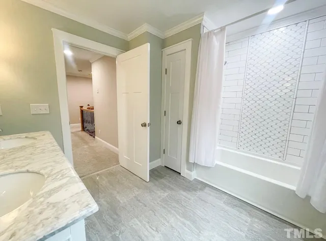 an empty room with a window and a ceiling fan