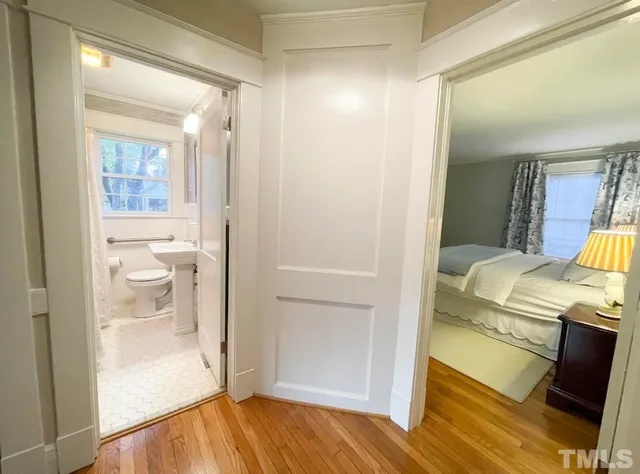a spacious bedroom with a bed and a walk in closet