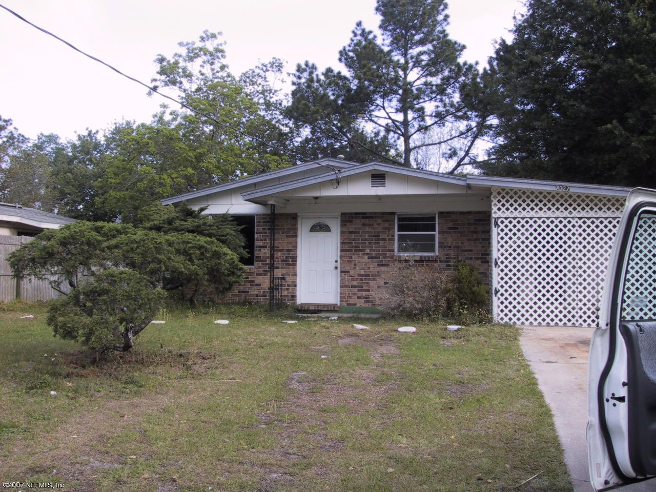 7327 Melvin Road Jacksonville, FL 32210 - Photo 1 of 2 a front view of a house with garden