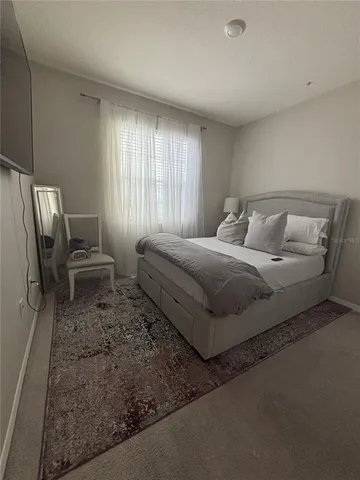 a bedroom with a bed and window