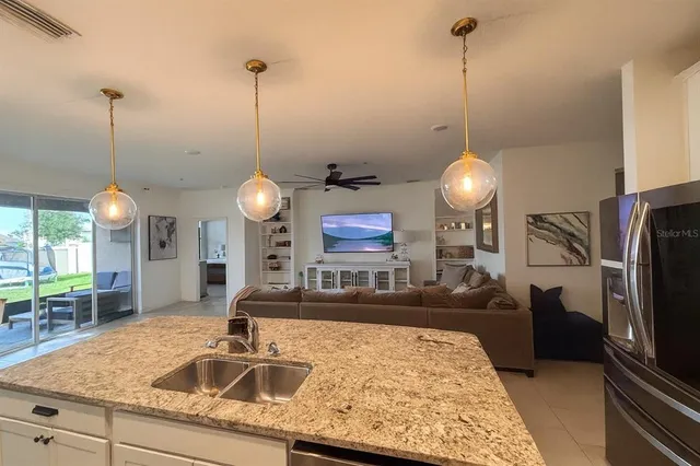 a bedroom with a bed a chair and large window