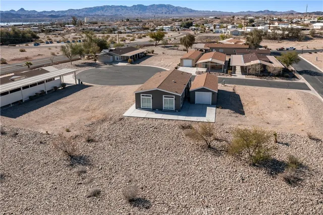 an aerial view of a house with a yard