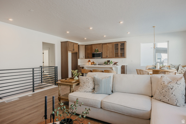 4595 North Fallow Way, Unit 511 Eagle Mountain, UT 84005 - Photo 11 of 32 Living room with light wood finished floors, recessed lighting, and a textured ceiling