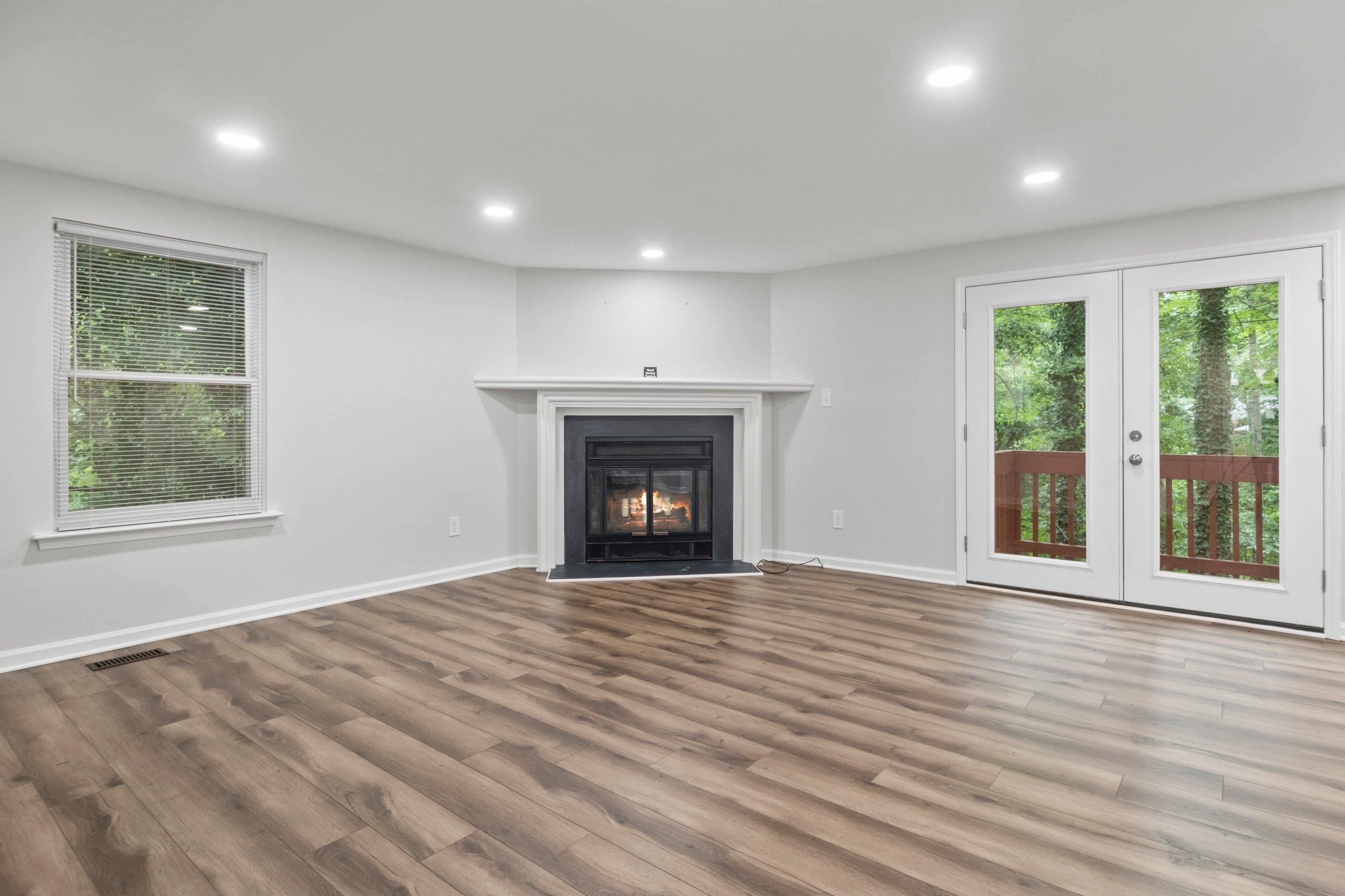 7286 Shellburne Drive Raleigh, NC 27612 - Photo 11 of 35 a view of an empty room with wooden floor and a window