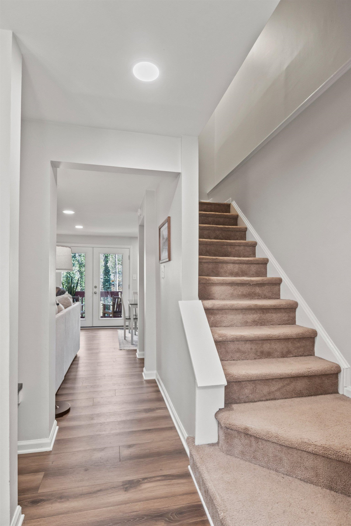 7286 Shellburne Drive Raleigh, NC 27612 - Photo 15 of 35 a view of a hallway with wooden floor and staircase