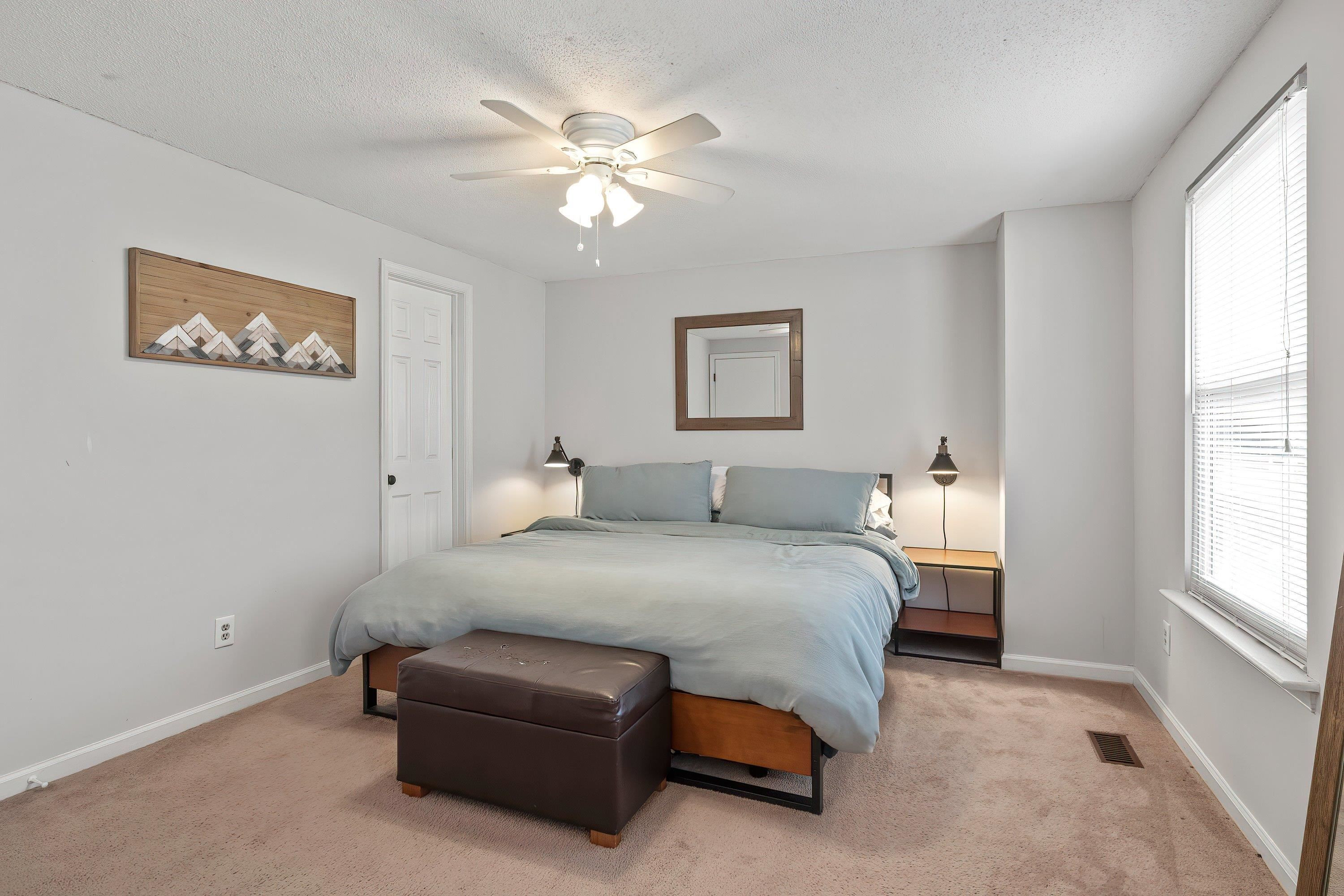 7286 Shellburne Drive Raleigh, NC 27612 - Photo 16 of 35 a spacious bedroom with a bed and a window