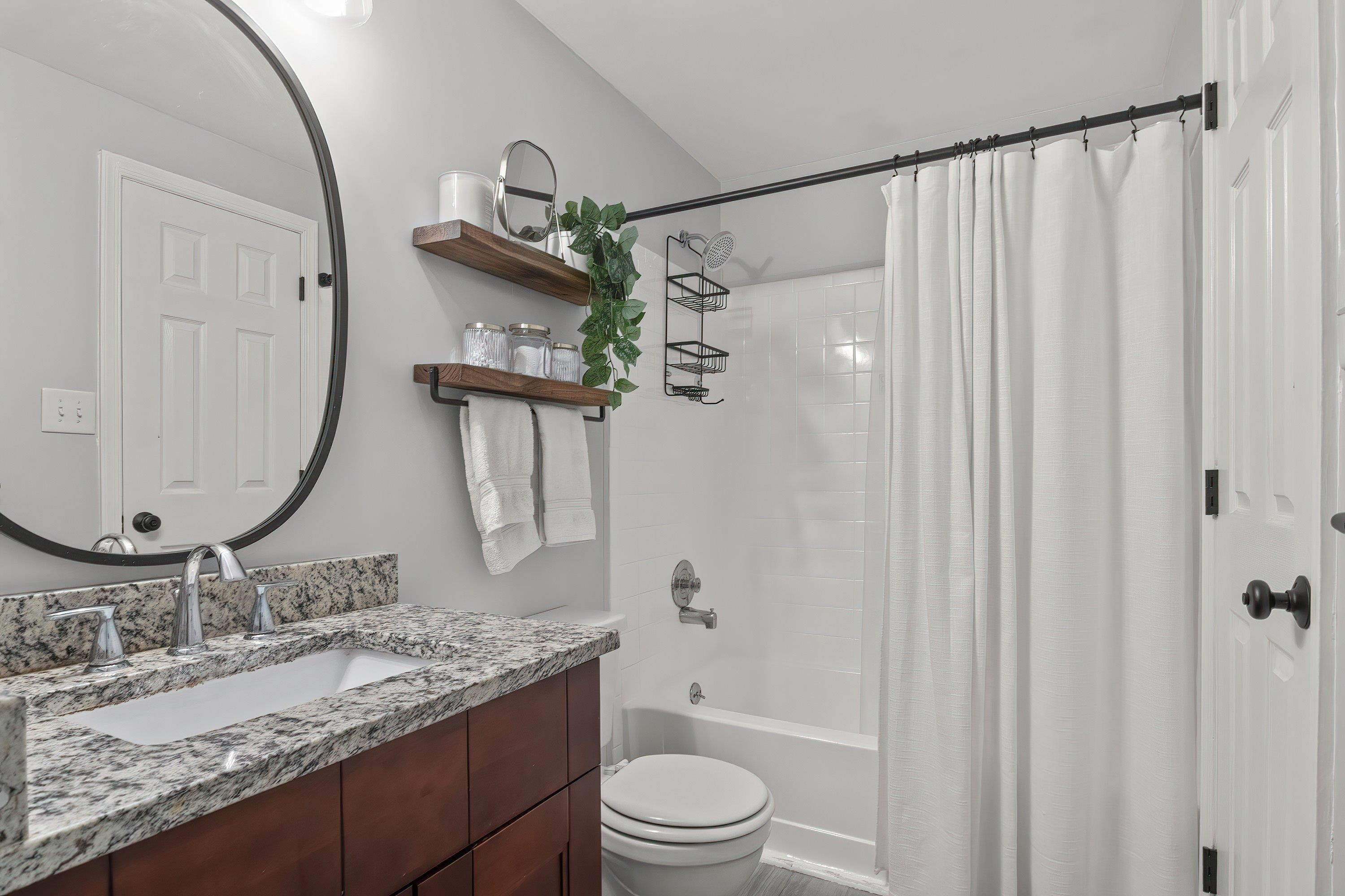 7286 Shellburne Drive Raleigh, NC 27612 - Photo 19 of 35 a bathroom with a granite countertop sink vanity mirror and shower