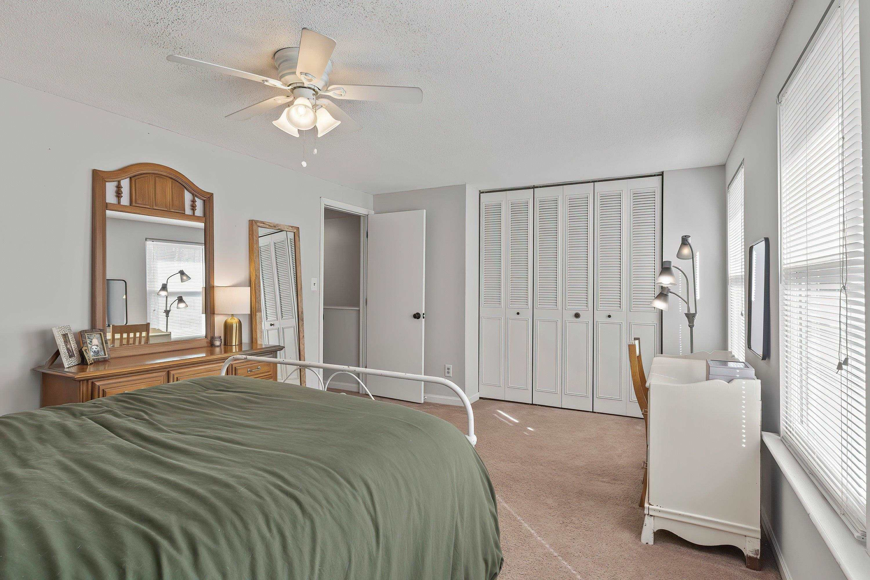 7286 Shellburne Drive Raleigh, NC 27612 - Photo 21 of 35 a bedroom with a large bed and a chandelier