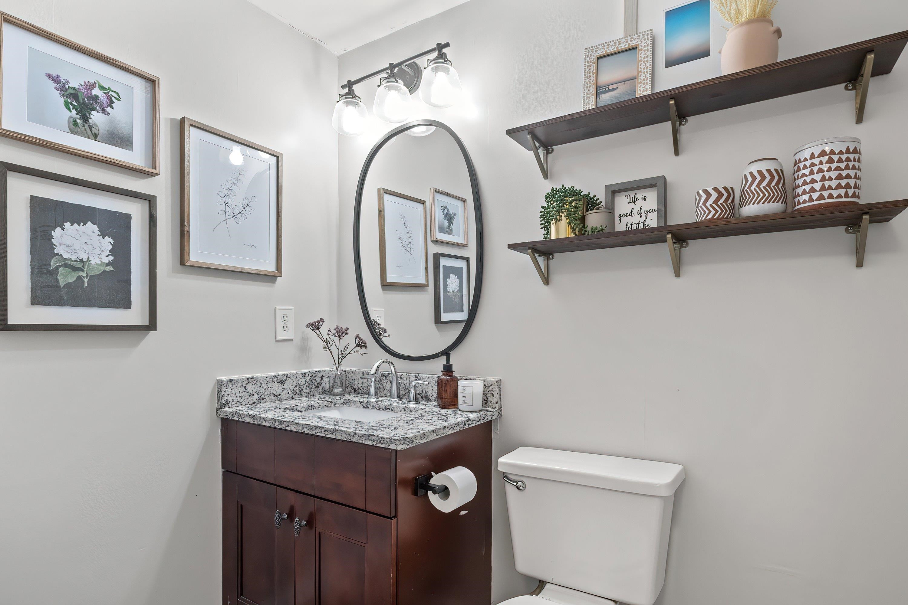 7286 Shellburne Drive Raleigh, NC 27612 - Photo 27 of 35 a bathroom with a granite countertop sink and a mirror