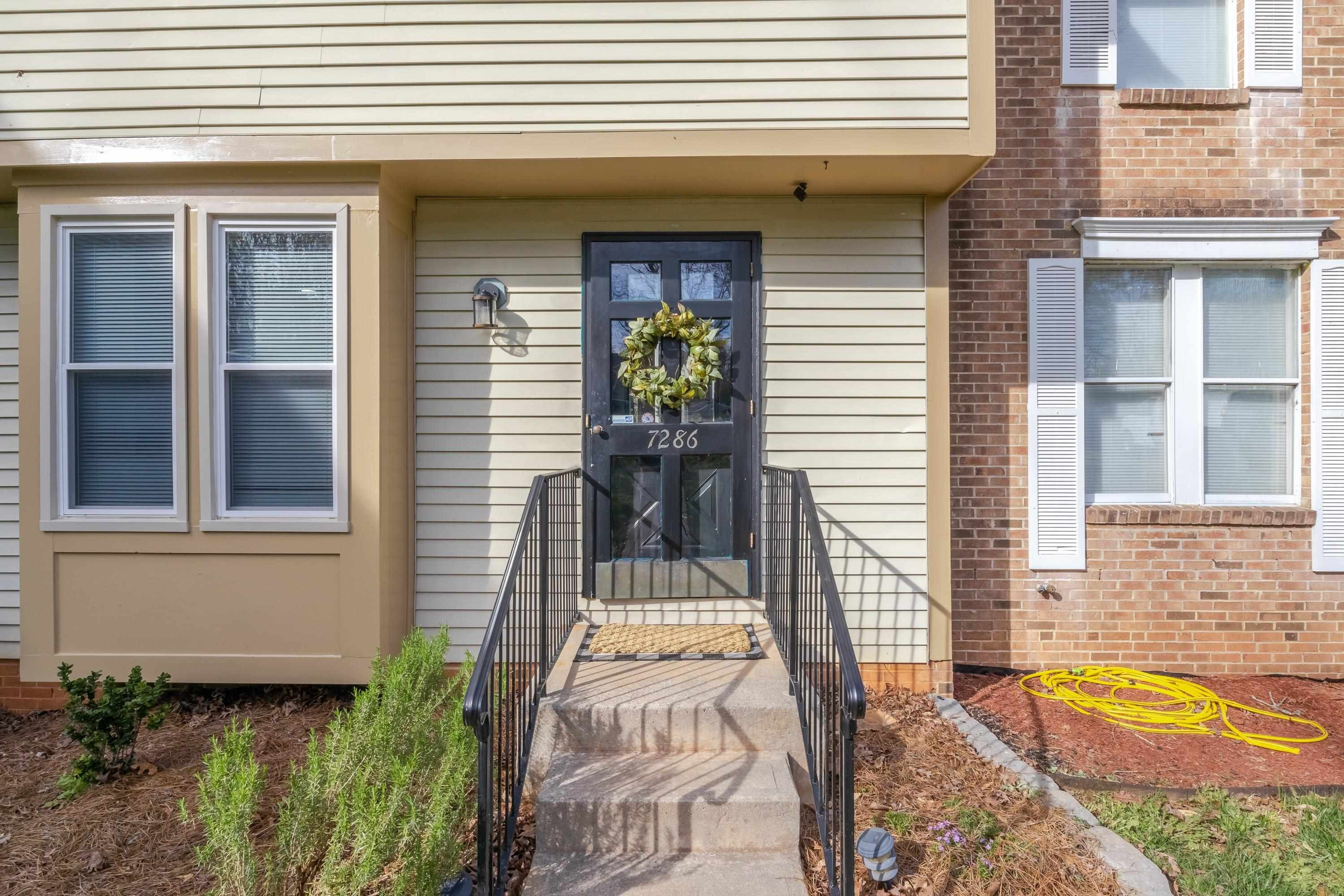7286 Shellburne Drive Raleigh, NC 27612 - Photo 35 of 35 a view of a house with potted plants and a table and chair