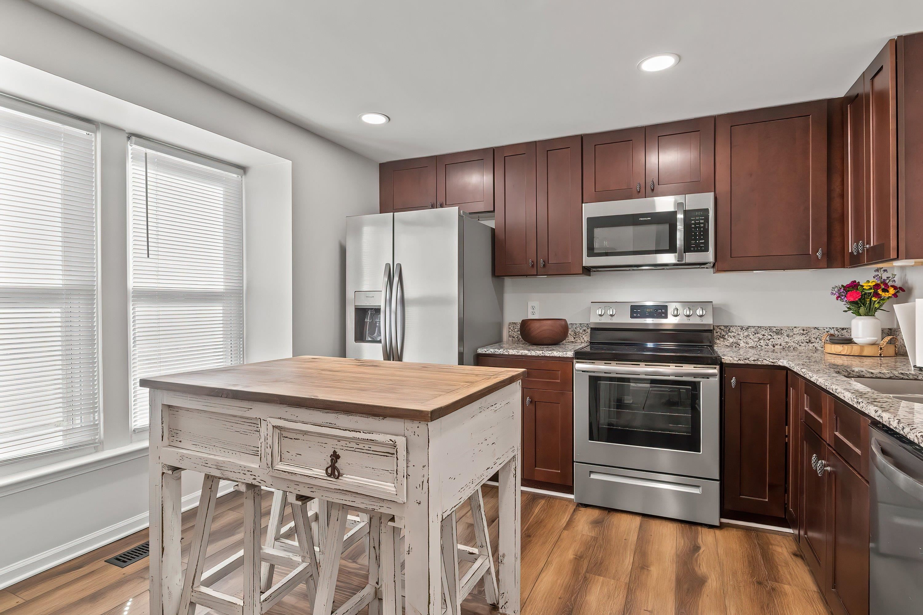 7286 Shellburne Drive Raleigh, NC 27612 - Photo 4 of 35 a kitchen with a stove a sink and a microwave