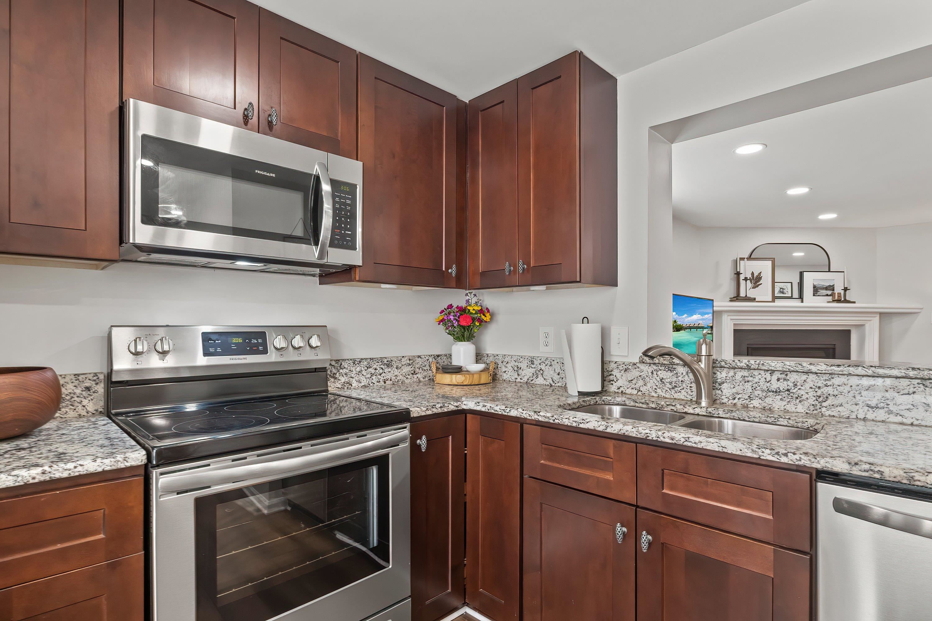 7286 Shellburne Drive Raleigh, NC 27612 - Photo 7 of 35 a kitchen with granite countertop a stove sink and microwave