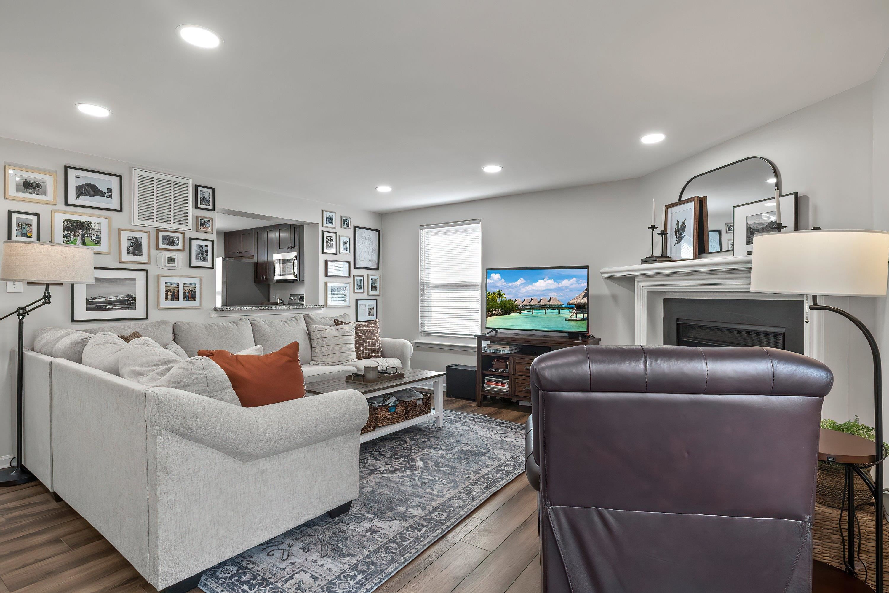 7286 Shellburne Drive Raleigh, NC 27612 - Photo 10 of 35 a living room with fireplace furniture and a wooden floor