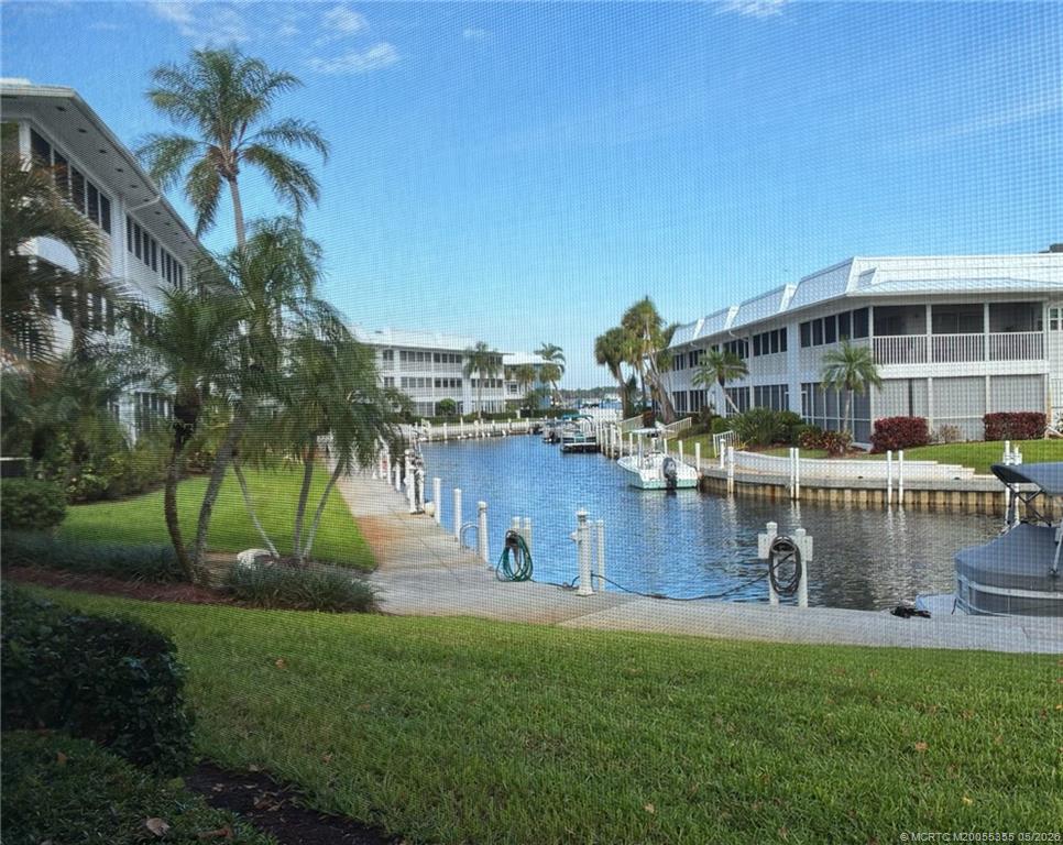 1862 Southwest Palm City Road, Unit 103 Stuart, FL 34994 - Photo 2 of 28 a front view of a house with garden and sitting area