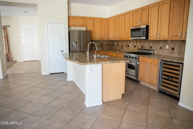 a kitchen with stainless steel appliances granite countertop a sink stove and cabinets