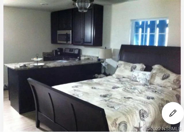 a kitchen with a wooden floor and cabinets