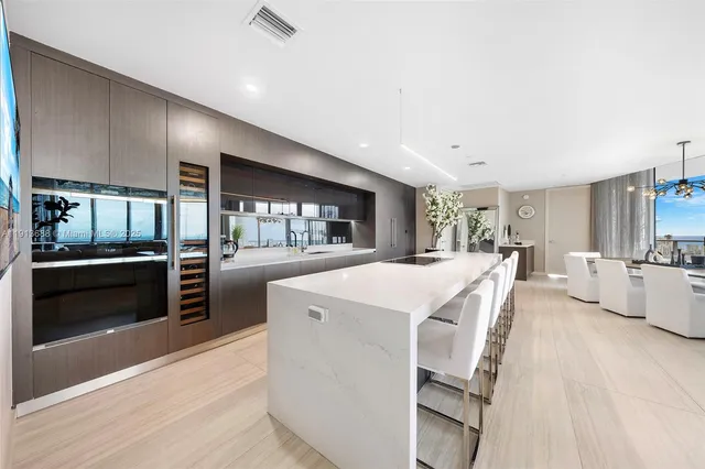 a dining room with furniture and a kitchen view