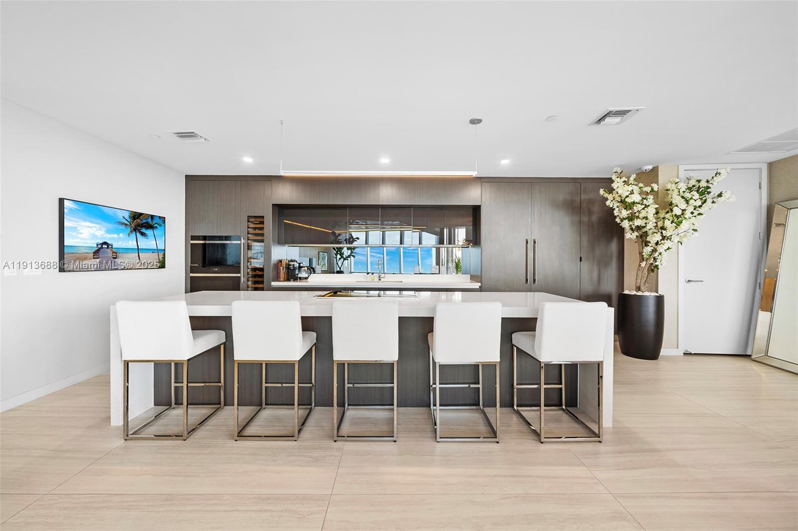 851 Northeast 1st Avenue, Unit 5312 Miami, FL 33132 - Photo 14 of 53 a dining room with furniture and a kitchen view