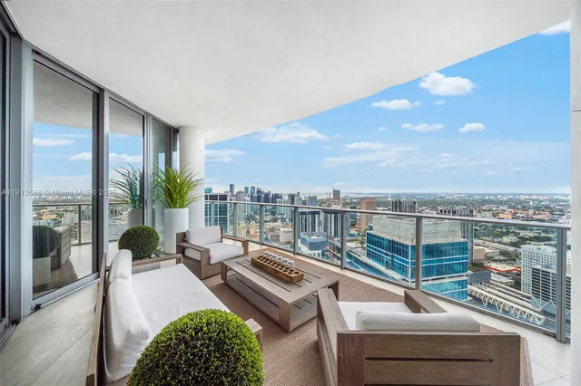 a view of a balcony with couches and wooden floor