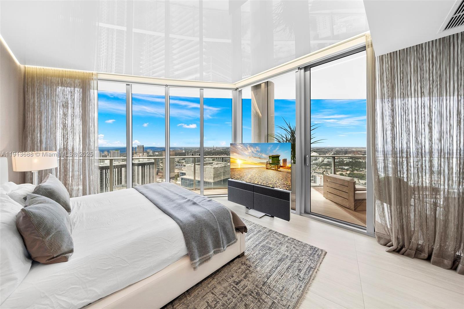 851 Northeast 1st Avenue, Unit 5312 Miami, FL 33132 - Photo 26 of 53 a bedroom with a large bed and a large window with balcony view