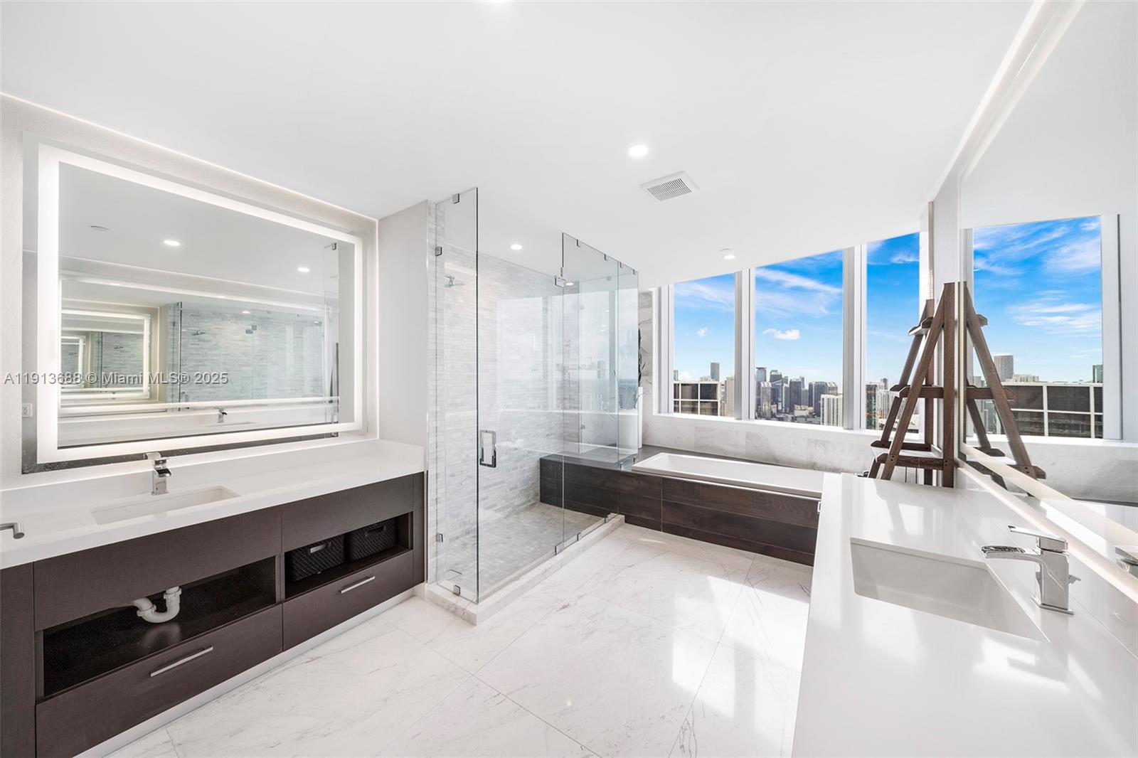 851 Northeast 1st Avenue, Unit 5312 Miami, FL 33132 - Photo 28 of 53 a spacious bathroom with a double vanity sink and a large mirror