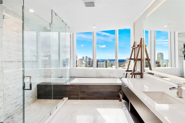 a large bathroom with a large tub and shower