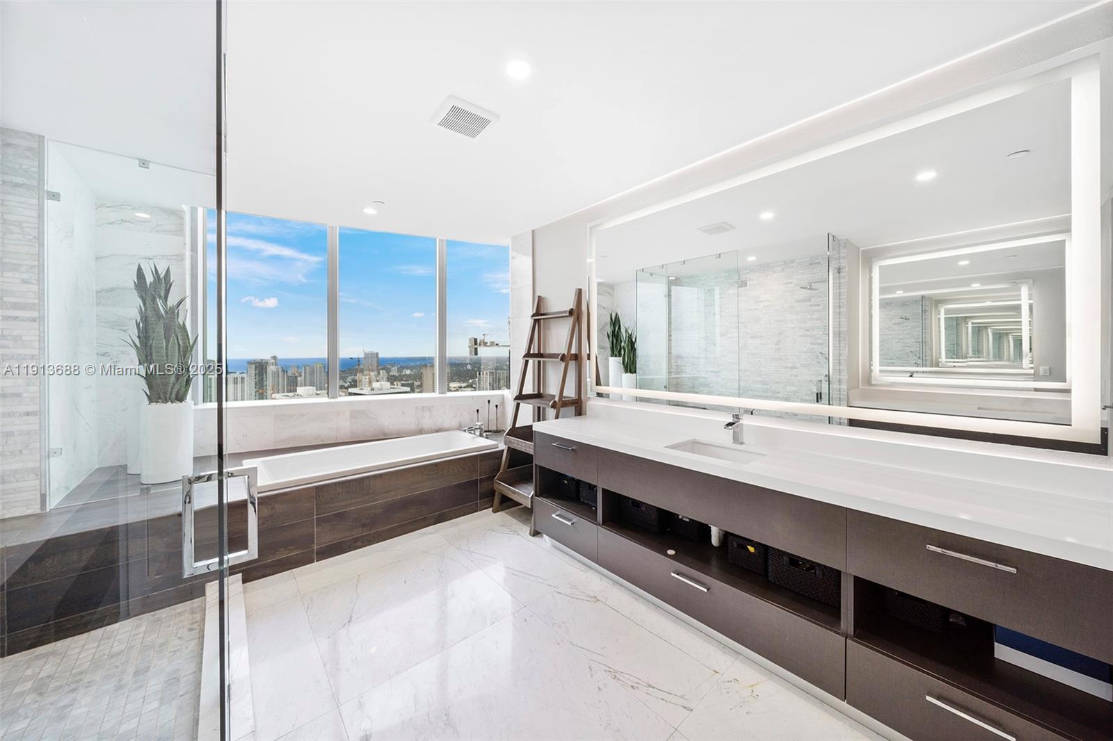 851 Northeast 1st Avenue, Unit 5312 Miami, FL 33132 - Photo 31 of 53 a large bathroom with a large tub and shower