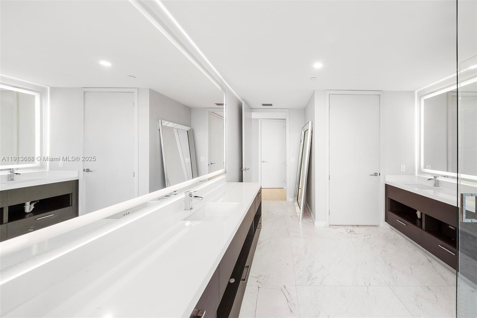 851 Northeast 1st Avenue, Unit 5312 Miami, FL 33132 - Photo 33 of 53 a spacious bathroom with a double vanity sink a large mirror and shower